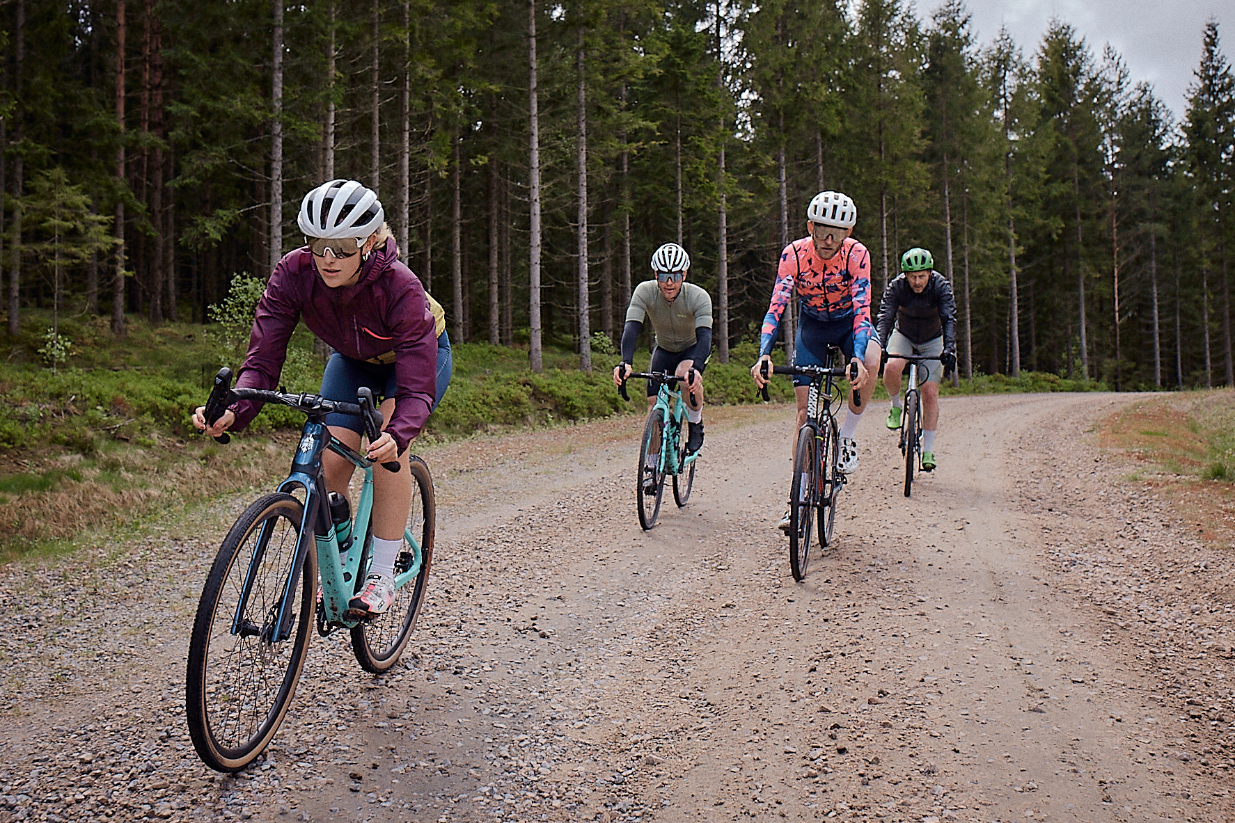 En kvartett gravel cyklister på grusväg i skogarna kring Isaberg